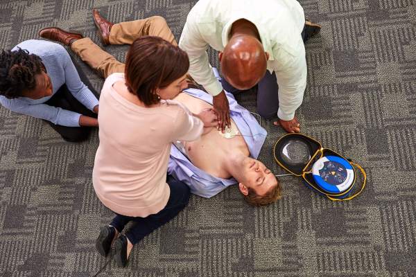 HeartSine SAM 500P action image on office floor